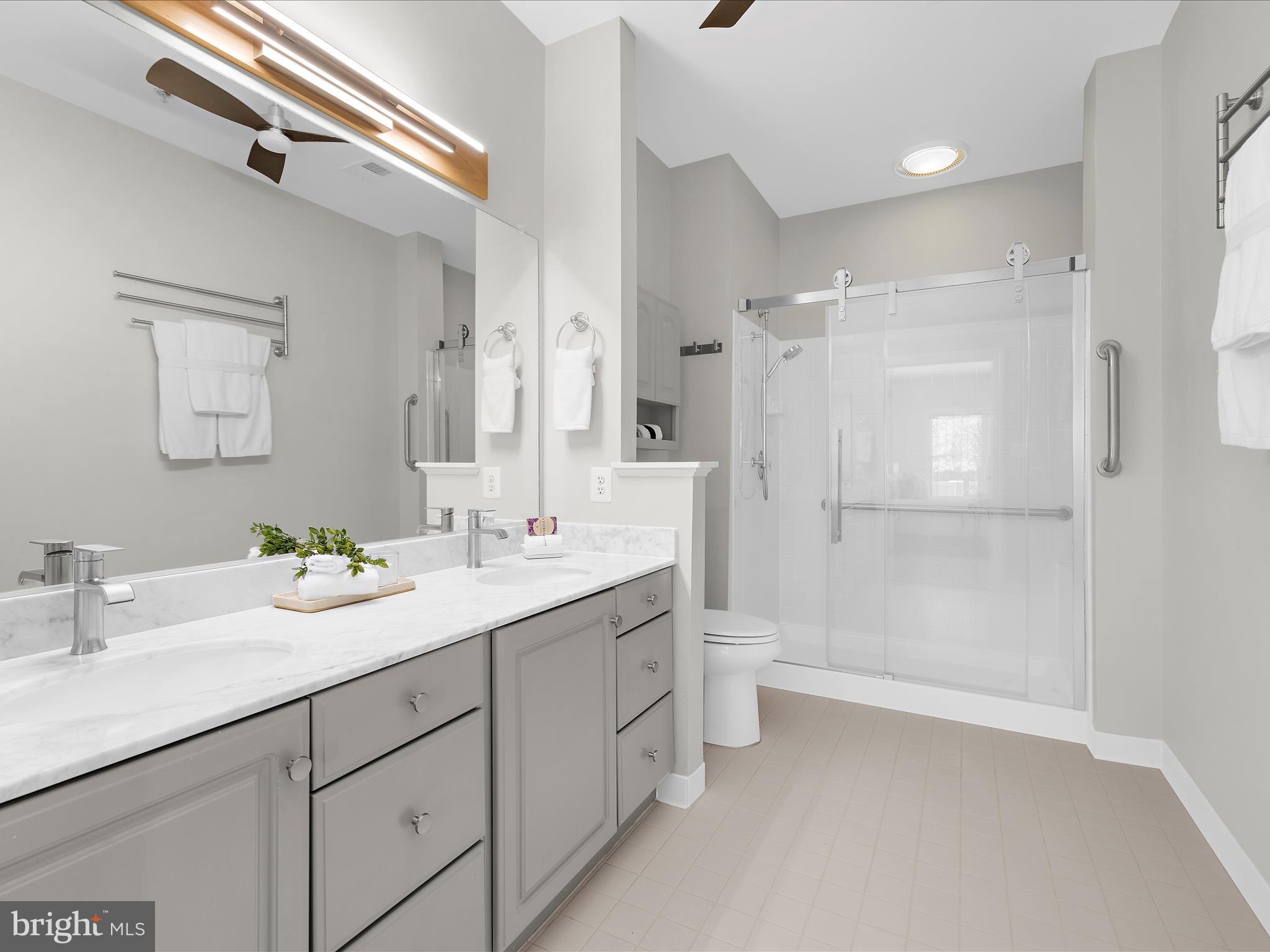 301 Colony Point Place Edgewater, MD 21037 - Photo 27 of 45 a bathroom with a double vanity sink mirror and shower