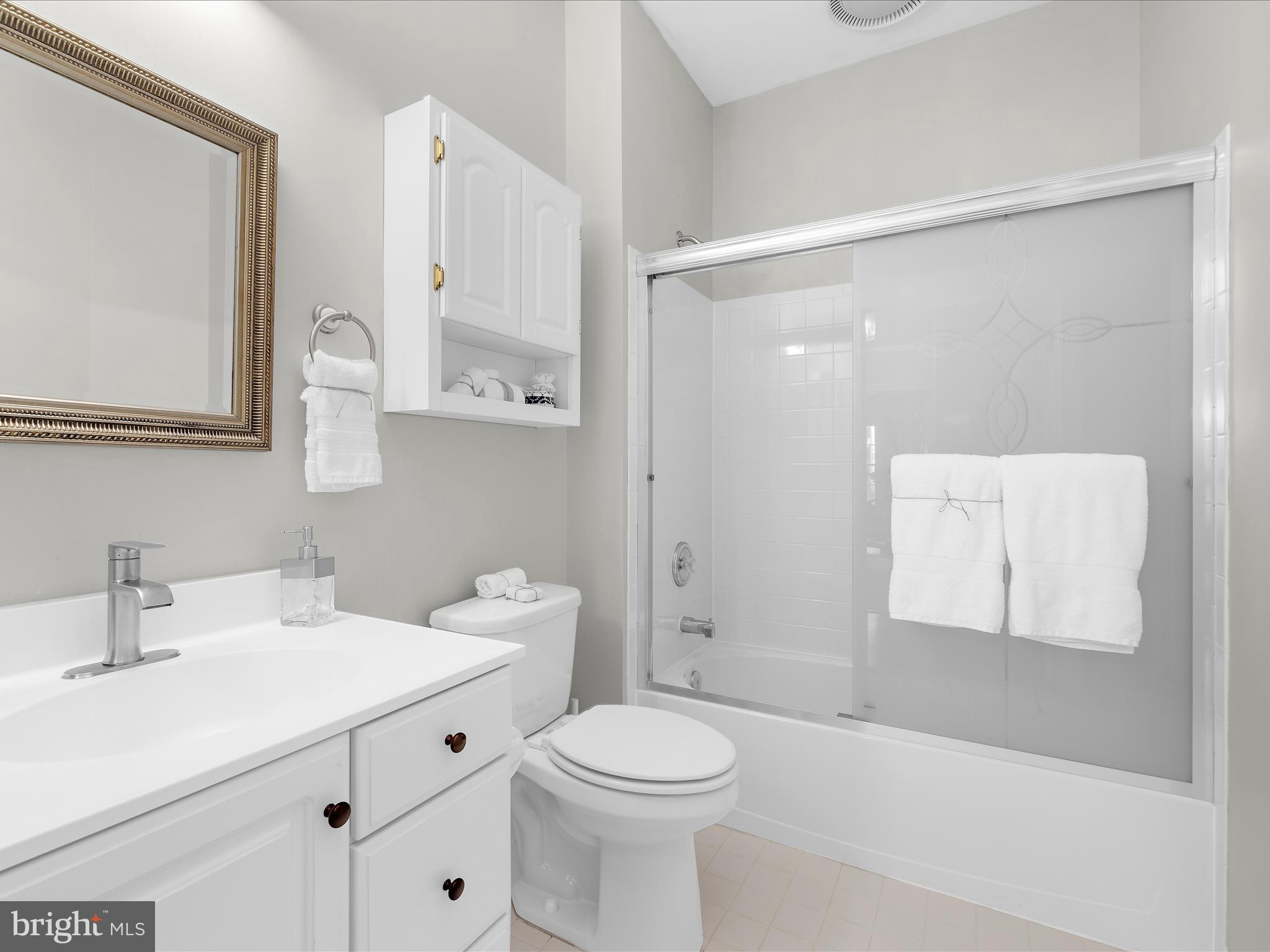 301 Colony Point Place Edgewater, MD 21037 - Photo 31 of 45 a bathroom with a sink mirror vanity and toilet