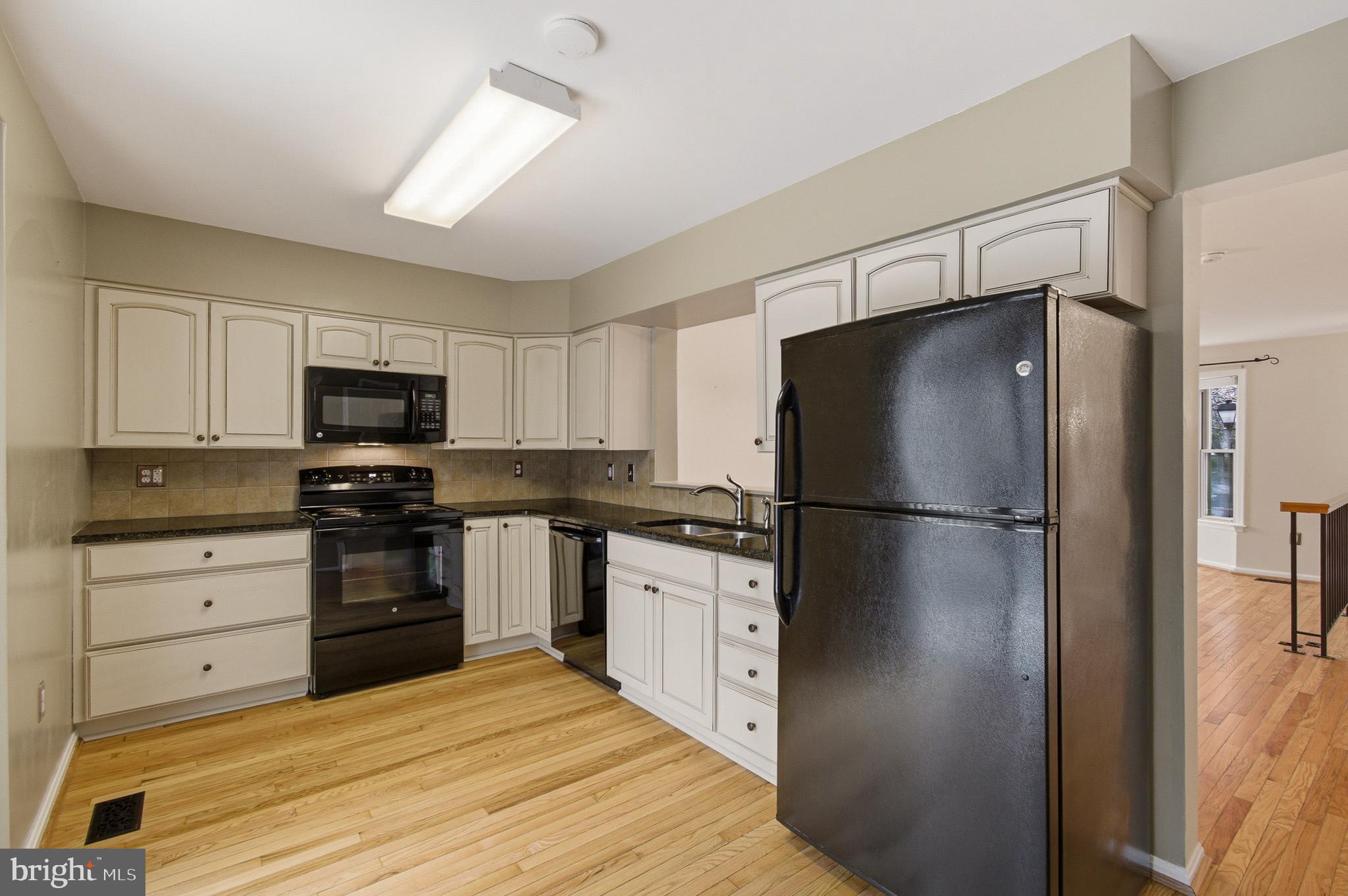 2036 Howard Chapel Turn Crofton, MD 21114 - Photo 14 of 55 a kitchen with a refrigerator and a stove top oven