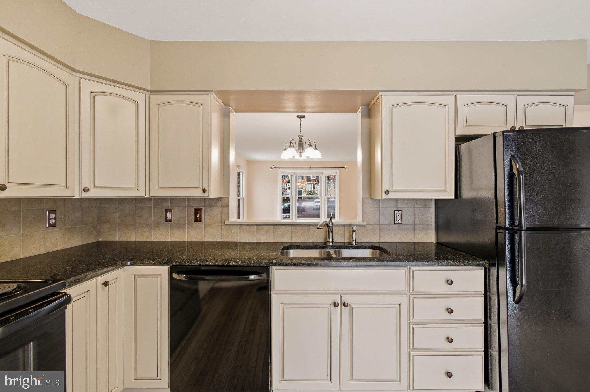 2036 Howard Chapel Turn Crofton, MD 21114 - Photo 16 of 55 a kitchen with granite countertop a refrigerator and a sink