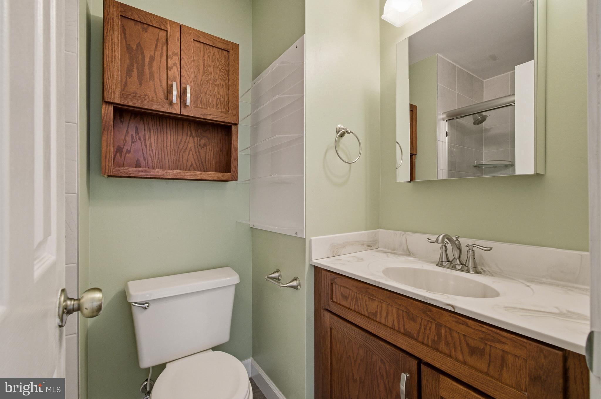 2036 Howard Chapel Turn Crofton, MD 21114 - Photo 35 of 55 a bathroom with a toilet sink and mirror