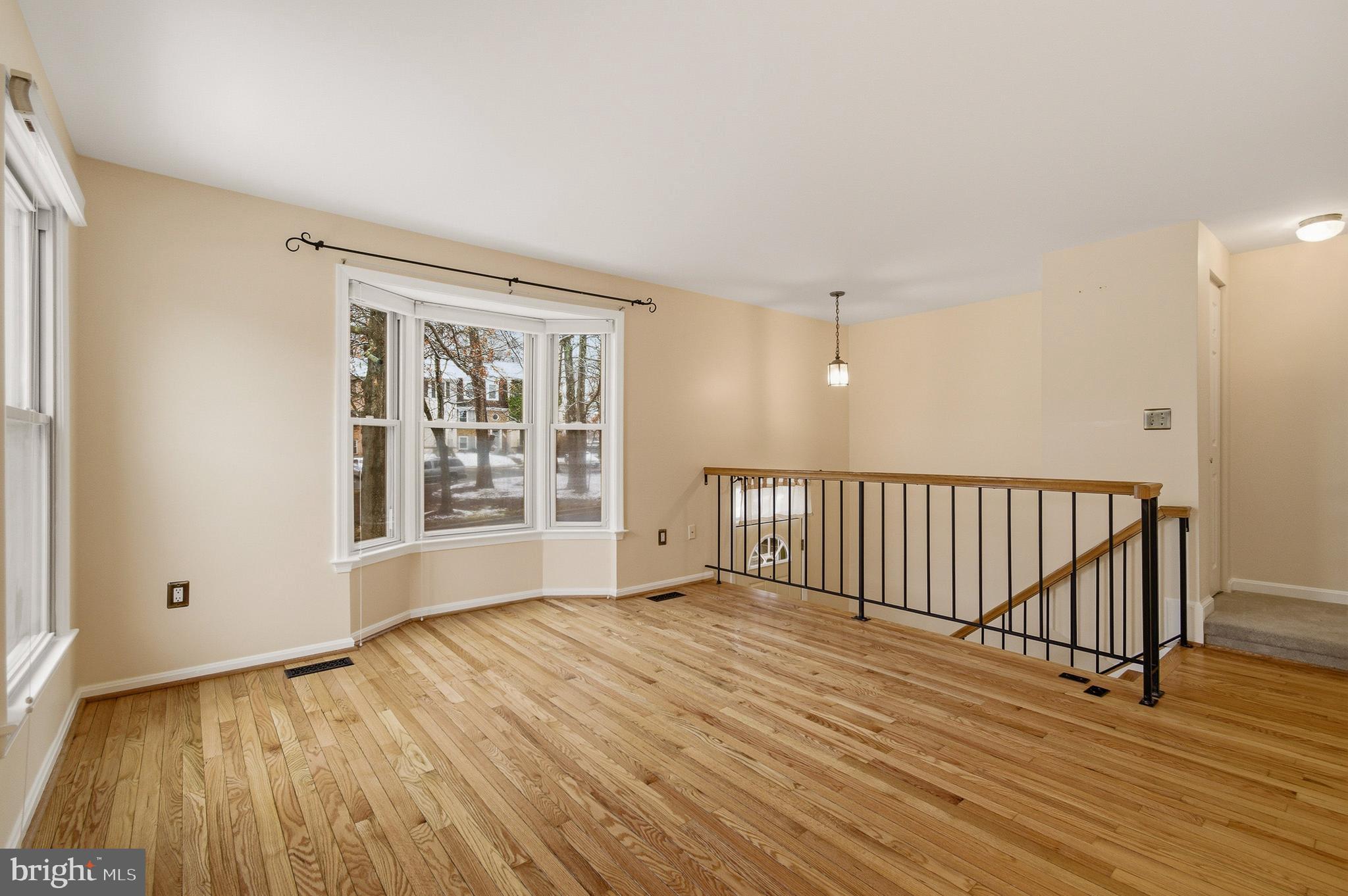 2036 Howard Chapel Turn Crofton, MD 21114 - Photo 6 of 55 a view of an empty room with wooden floor and a window