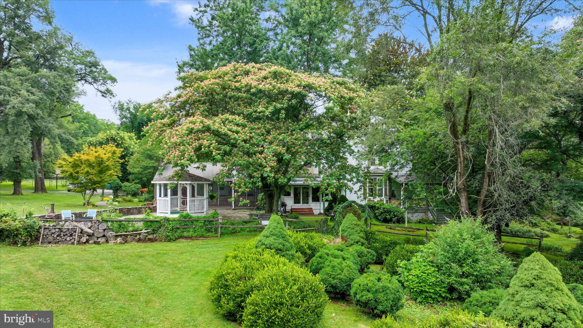 6739 South Clifton Road Frederick, MD 21703 - Photo 4 of 53 Lush greenery surrounds a charming home.