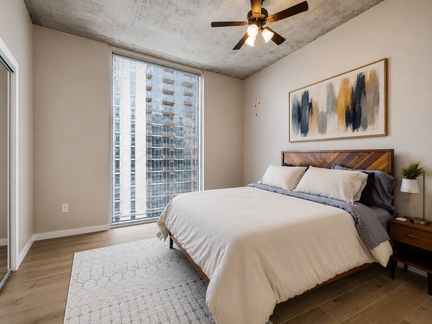 5925 Almeda Road, Unit 12202 Houston, TX 77004 - Photo 11 of 33 Versatile secondary bedroom offers plenty of space for guests, a home office, or a flex room. Large windows provide abundant natural light, while the industrial concrete ceiling with nice fan.