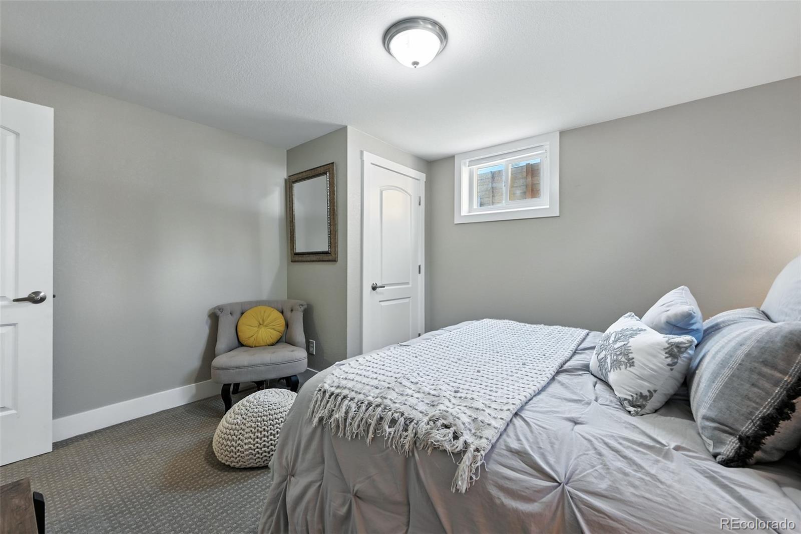 2714 South Raleigh Street Denver, CO 80236 - Photo 27 of 34 a bedroom with a bed and a window