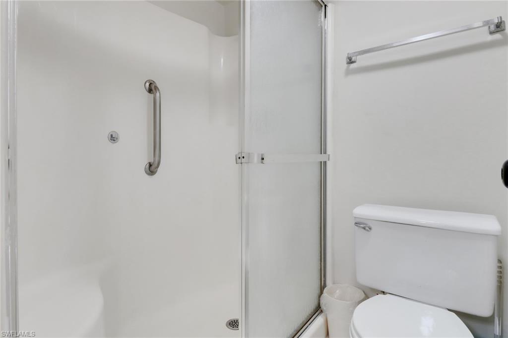 7077 Quail Run Court East, Unit A 15 Fort Myers, FL 33908 - Photo 11 of 43 a white toilet sitting next to a shower