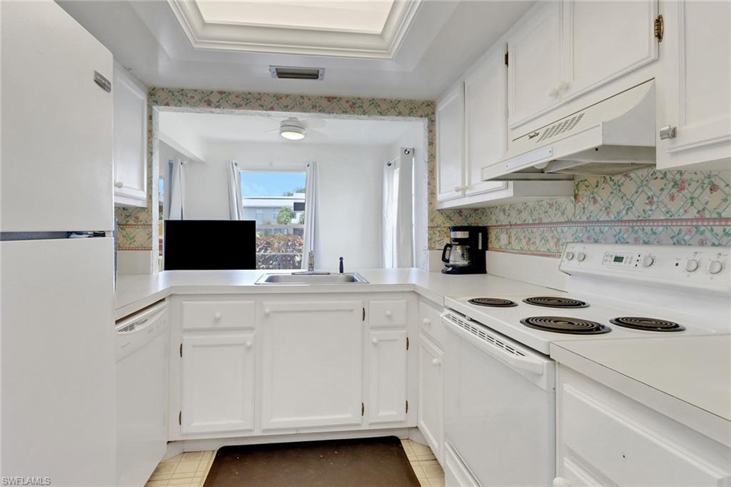 7077 Quail Run Court East, Unit A 15 Fort Myers, FL 33908 - Photo 20 of 43 a kitchen with a sink and white cabinets