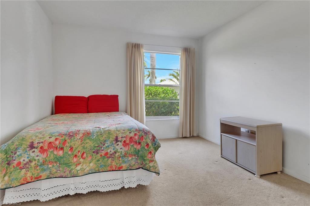 7077 Quail Run Court East, Unit A 15 Fort Myers, FL 33908 - Photo 22 of 43 a bedroom with a bed and a window