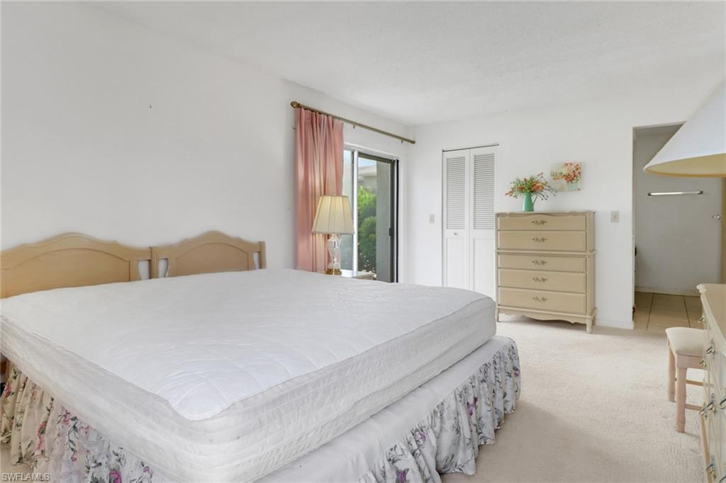 7077 Quail Run Court East, Unit A 15 Fort Myers, FL 33908 - Photo 26 of 43 a bedroom with a bed and a dresser