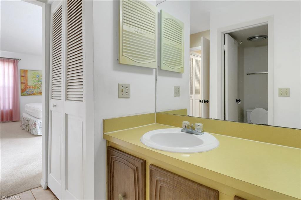 7077 Quail Run Court East, Unit A 15 Fort Myers, FL 33908 - Photo 27 of 43 a bathroom with a sink and a mirror