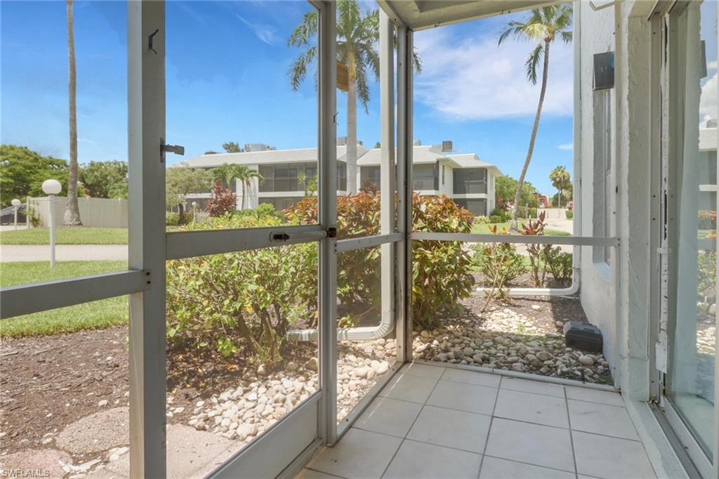 7077 Quail Run Court East, Unit A 15 Fort Myers, FL 33908 - Photo 28 of 43 a view of a glass door and porch