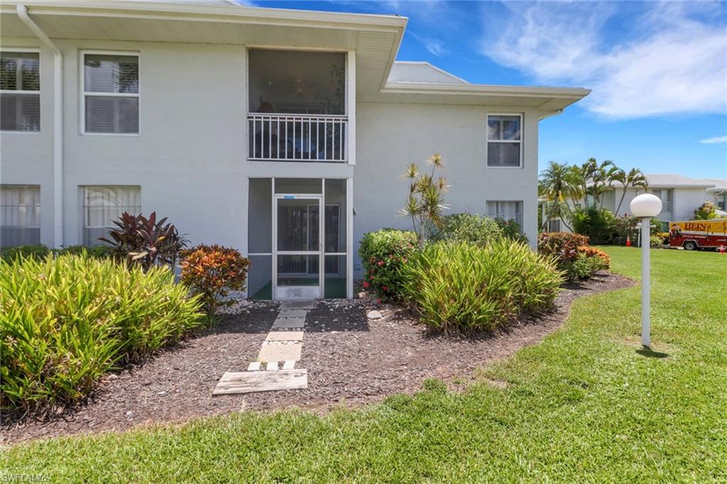 7077 Quail Run Court East, Unit A 15 Fort Myers, FL 33908 - Photo 4 of 43 a front view of a house with a yard