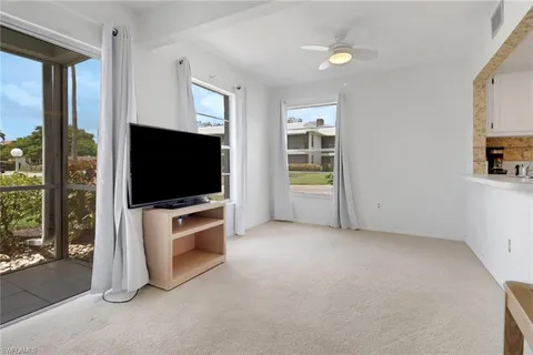 a kitchen with stainless steel appliances granite countertop a sink and a white cabinets
