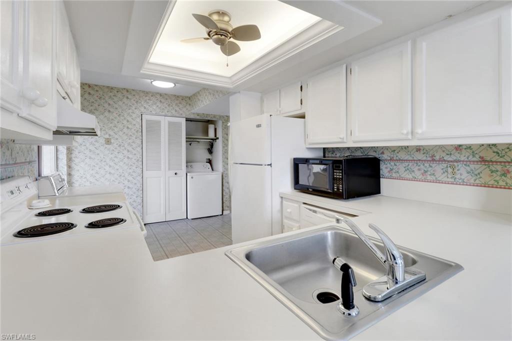 7077 Quail Run Court East, Unit A 15 Fort Myers, FL 33908 - Photo 7 of 43 a kitchen with stainless steel appliances granite countertop a sink and a white cabinets