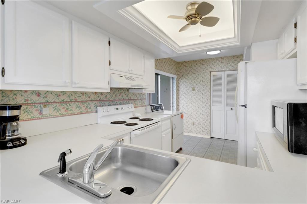 7077 Quail Run Court East, Unit A 15 Fort Myers, FL 33908 - Photo 8 of 43 a kitchen with stainless steel appliances granite countertop a sink and a refrigerator