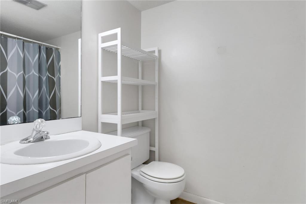 7077 Quail Run Court East, Unit A 15 Fort Myers, FL 33908 - Photo 10 of 43 a bathroom with a sink toilet and a mirror