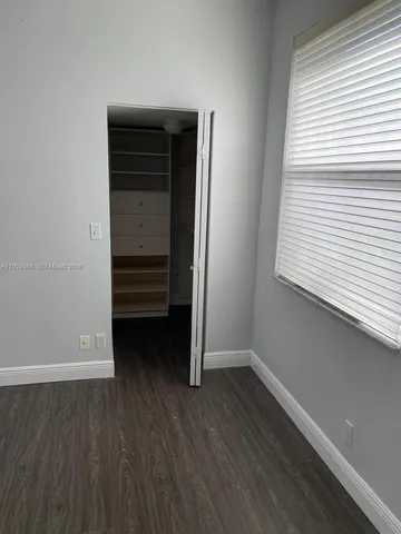 a kitchen that has a sink a window and cabinets