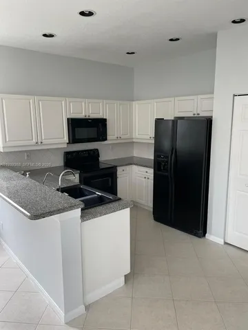 an empty room with sliding glass door and mountain view
