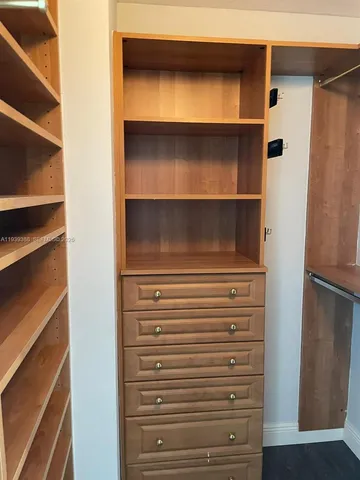 a bathroom with a granite countertop sink mirror and shower