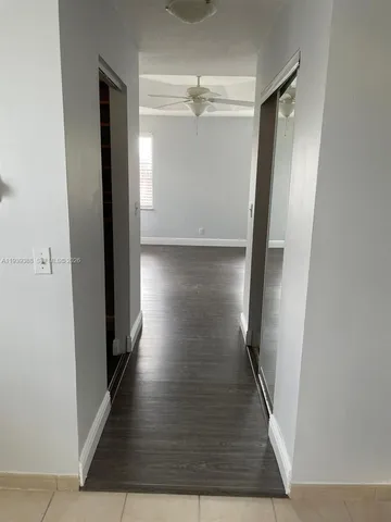 a view of a room with wooden floor and windows