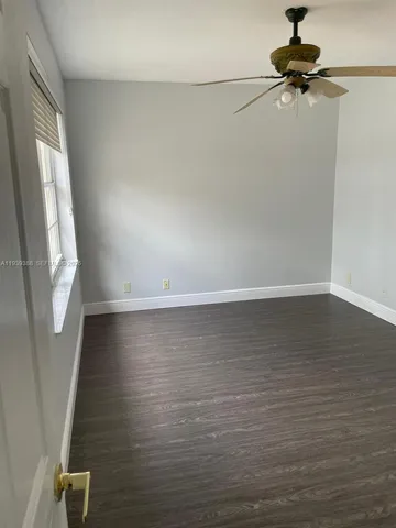 a bathroom with a granite countertop sink a toilet and a shower