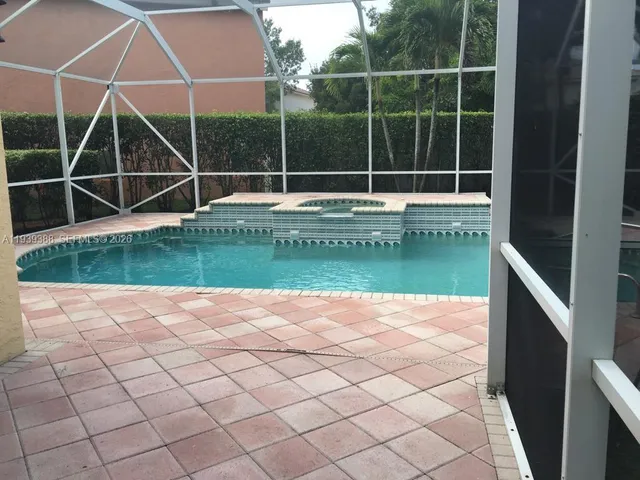 a view of a swimming pool with a small yard