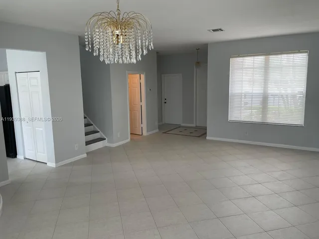 an empty room with windows and entrance