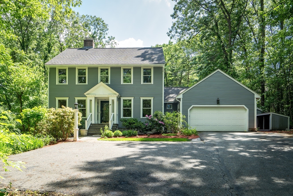 71 Grassland Street Lexington, MA 02421 - Photo 1 of 38 a front view of a house with a garden and plants