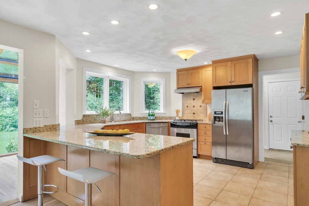 71 Grassland Street Lexington, MA 02421 - Photo 18 of 38 a kitchen with stainless steel appliances granite countertop a sink and a refrigerator