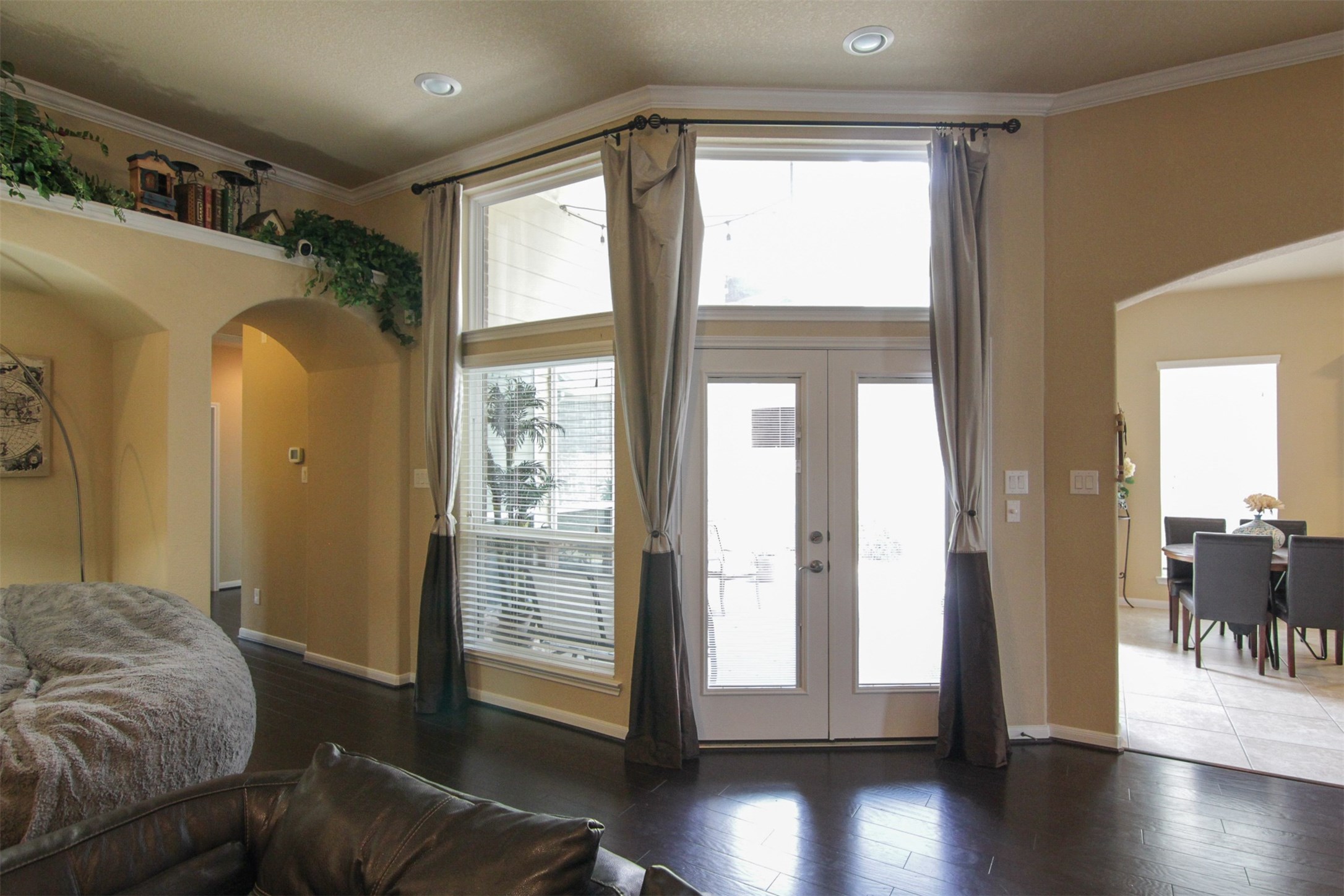 1423 Ralston Branch Way Sugar Land, TX 77479 - Photo 9 of 43 high ceiling; long curtains around French doors to back patio with more transom windows above; breakfast on right