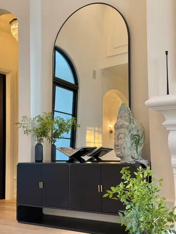 a living room with furniture and potted plant