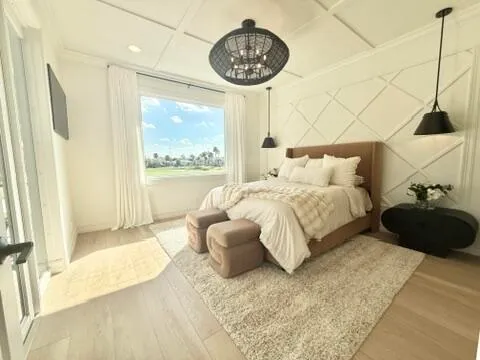 a bedroom with a bed mirror and window