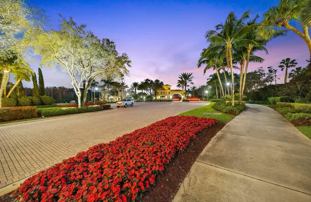 a living room with lots of furniture hardwood and a chandelier
