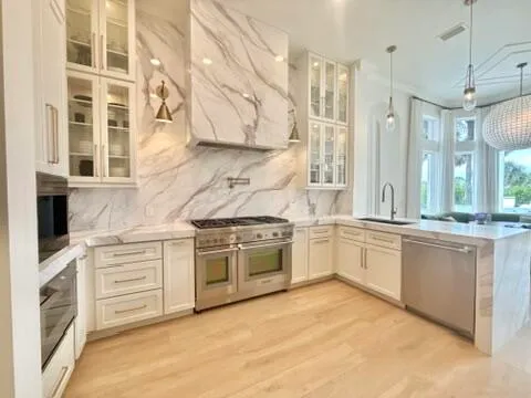 a kitchen with stainless steel appliances granite countertop a stove and a sink