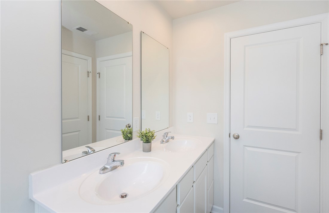 132 Bleckley Trail Anderson, SC 29625 - Photo 11 of 44 This bright bathroom features dual vanities, offering ample space and convenience for daily routines.