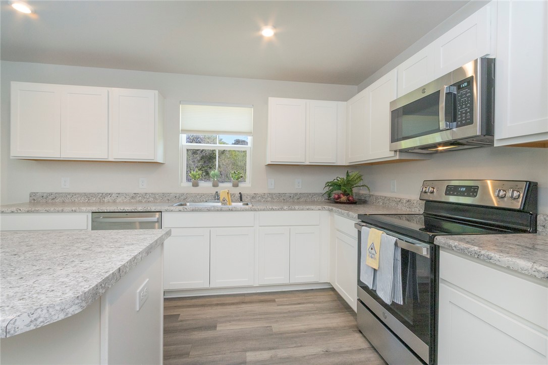 132 Bleckley Trail Anderson, SC 29625 - Photo 21 of 44 This modern kitchen features elegant countertops, abundant cabinetry, and durable flooring for everyday living.