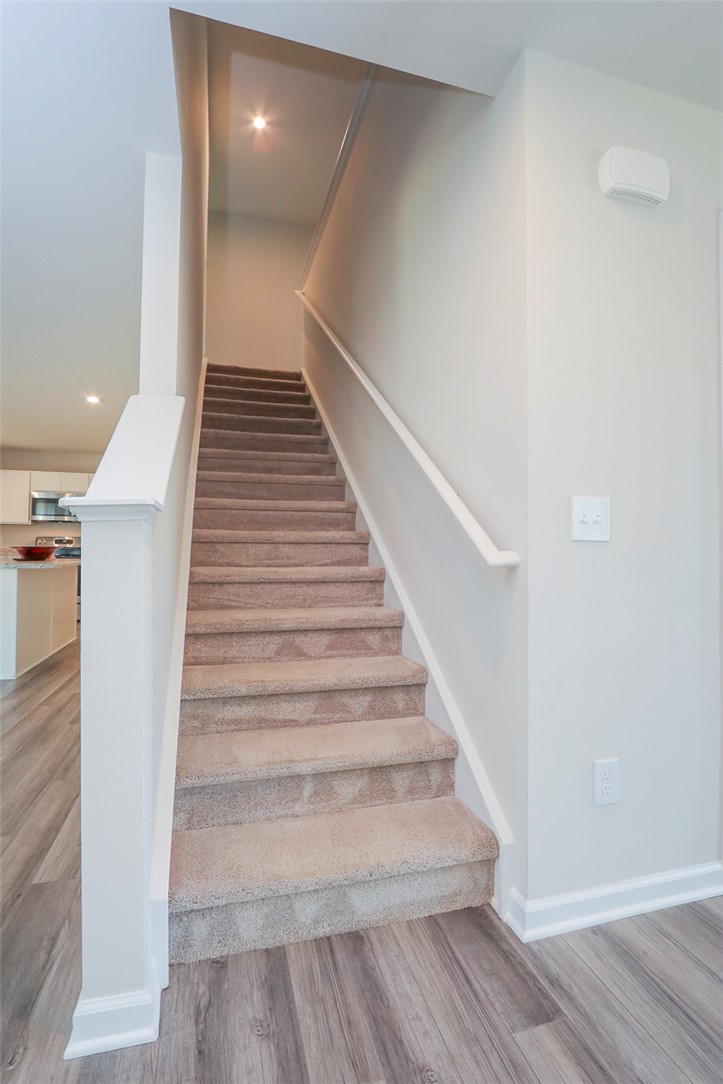 132 Bleckley Trail Anderson, SC 29625 - Photo 22 of 44 Ascend to comfort with this inviting carpeted staircase, featuring modern wood flooring and bright lighting.