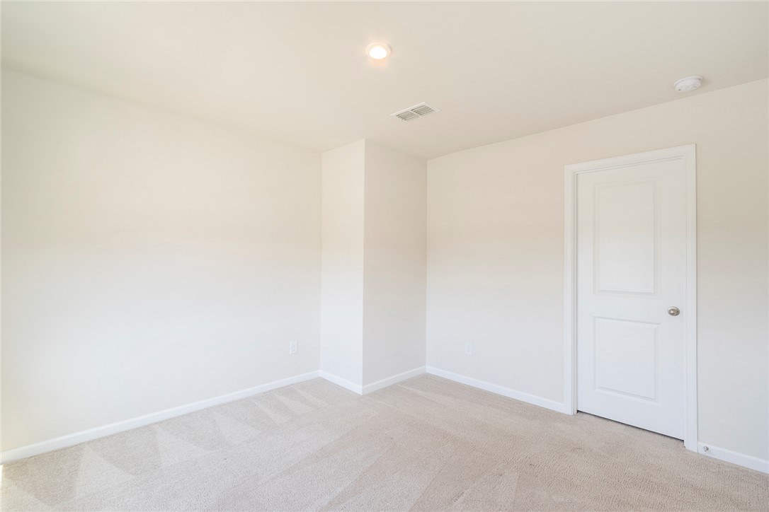 132 Bleckley Trail Anderson, SC 29625 - Photo 24 of 44 This spacious room features neutral carpet and a classic white panel door, ready for your personal touch.
