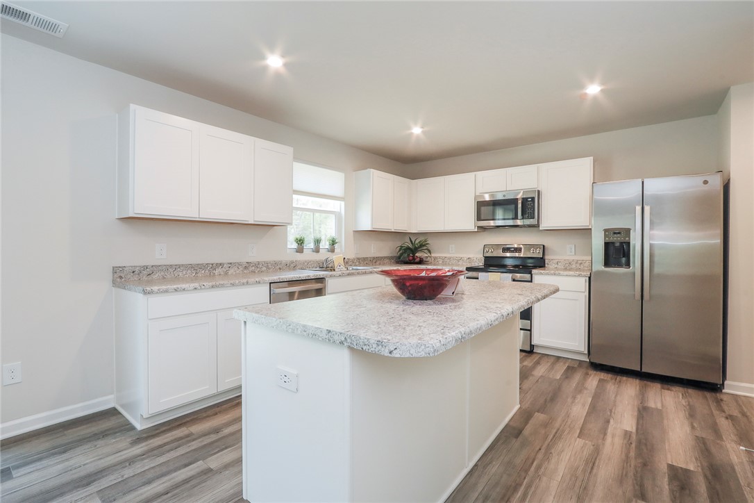 132 Bleckley Trail Anderson, SC 29625 - Photo 3 of 44 This modern kitchen features bright cabinetry, an expansive island, and ample counter space for culinary creativity.