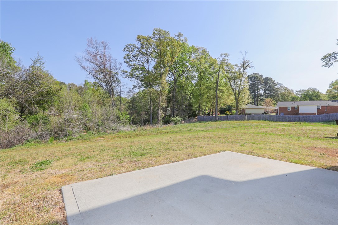 132 Bleckley Trail Anderson, SC 29625 - Photo 37 of 44 This spacious yard offers ample outdoor living potential, framed by lush trees and a clear sky.