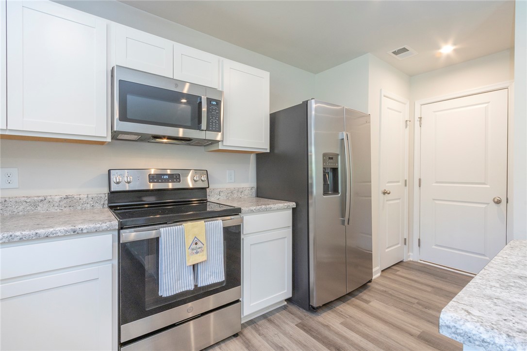 132 Bleckley Trail Anderson, SC 29625 - Photo 40 of 44 Modern kitchen with sleek countertops and integrated appliances.