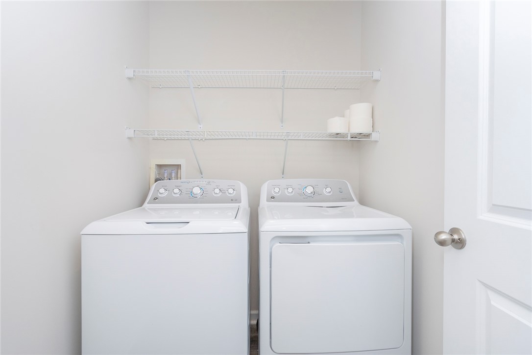 132 Bleckley Trail Anderson, SC 29625 - Photo 10 of 44 This laundry area features convenient appliances and practical shelving.