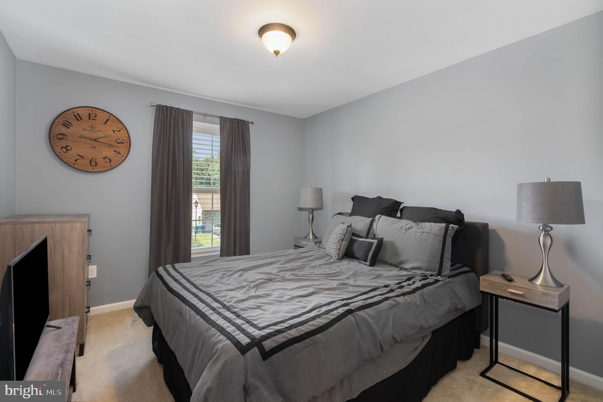 471 Nursery Drive North Mechanicsburg, PA 17055 - Photo 19 of 25 a bedroom with a bed and a lamp on dresser next to a window