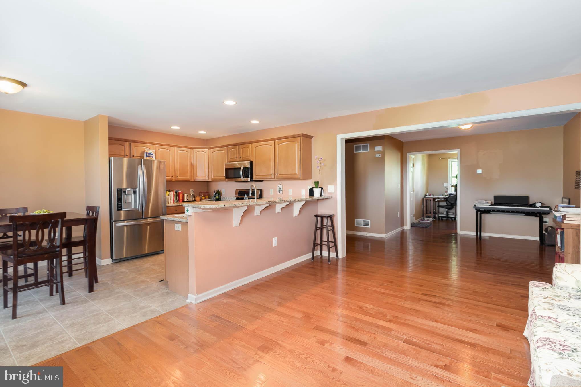 471 Nursery Drive North Mechanicsburg, PA 17055 - Photo 8 of 25 a kitchen with a refrigerator a dining table and chairs