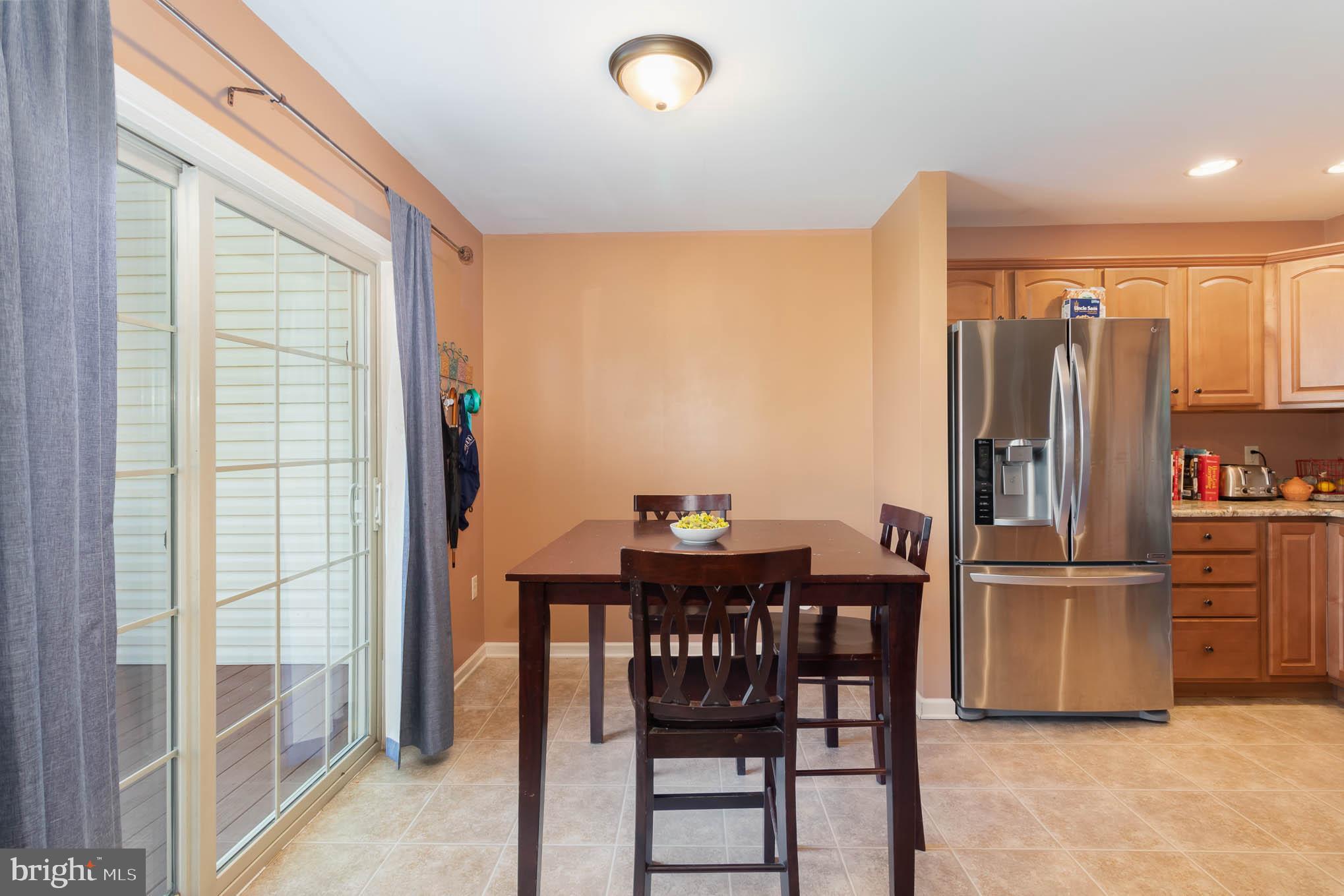 471 Nursery Drive North Mechanicsburg, PA 17055 - Photo 9 of 25 a kitchen with stainless steel appliances a refrigerator a stove a dining table and chairs