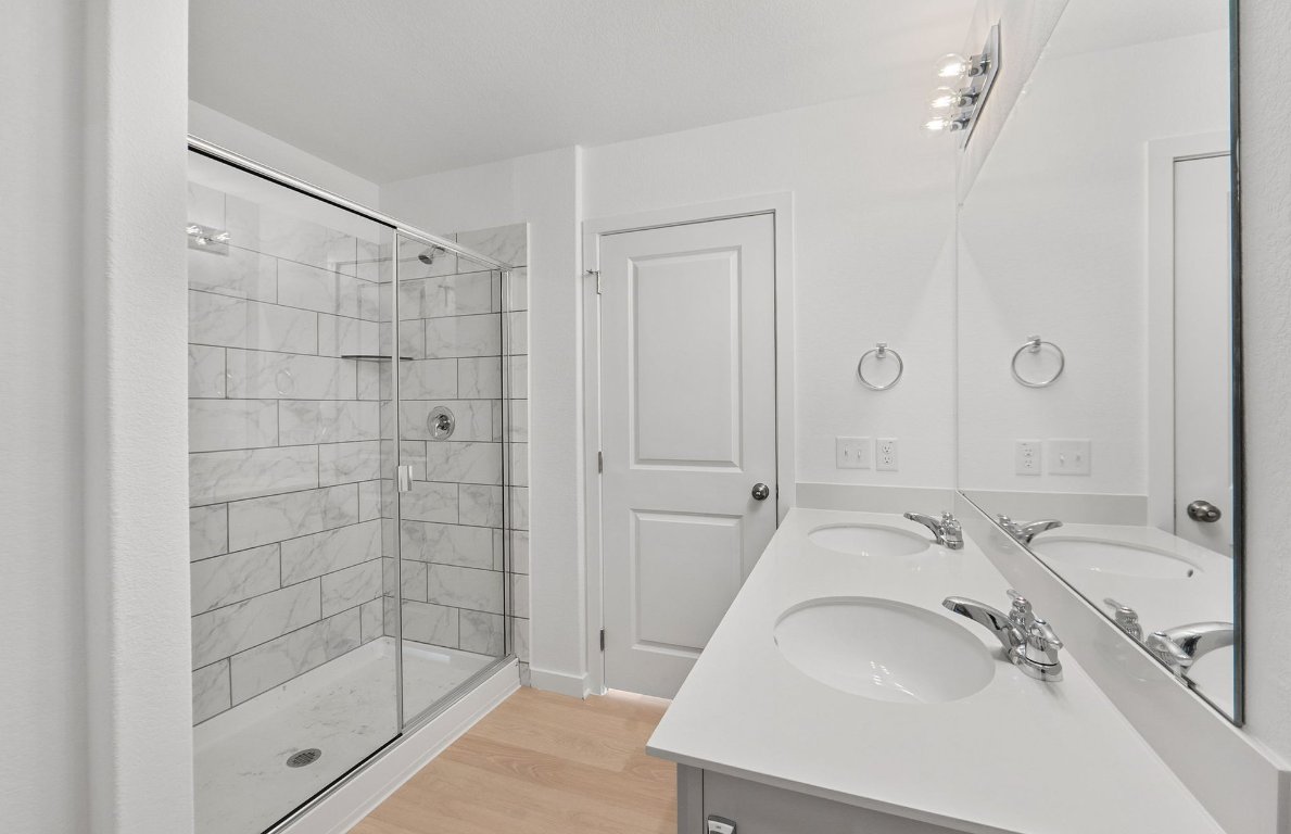 400 Sullivan Way Elgin, TX 78621 - Photo 15 of 30 a bathroom with a sink a mirror and shower