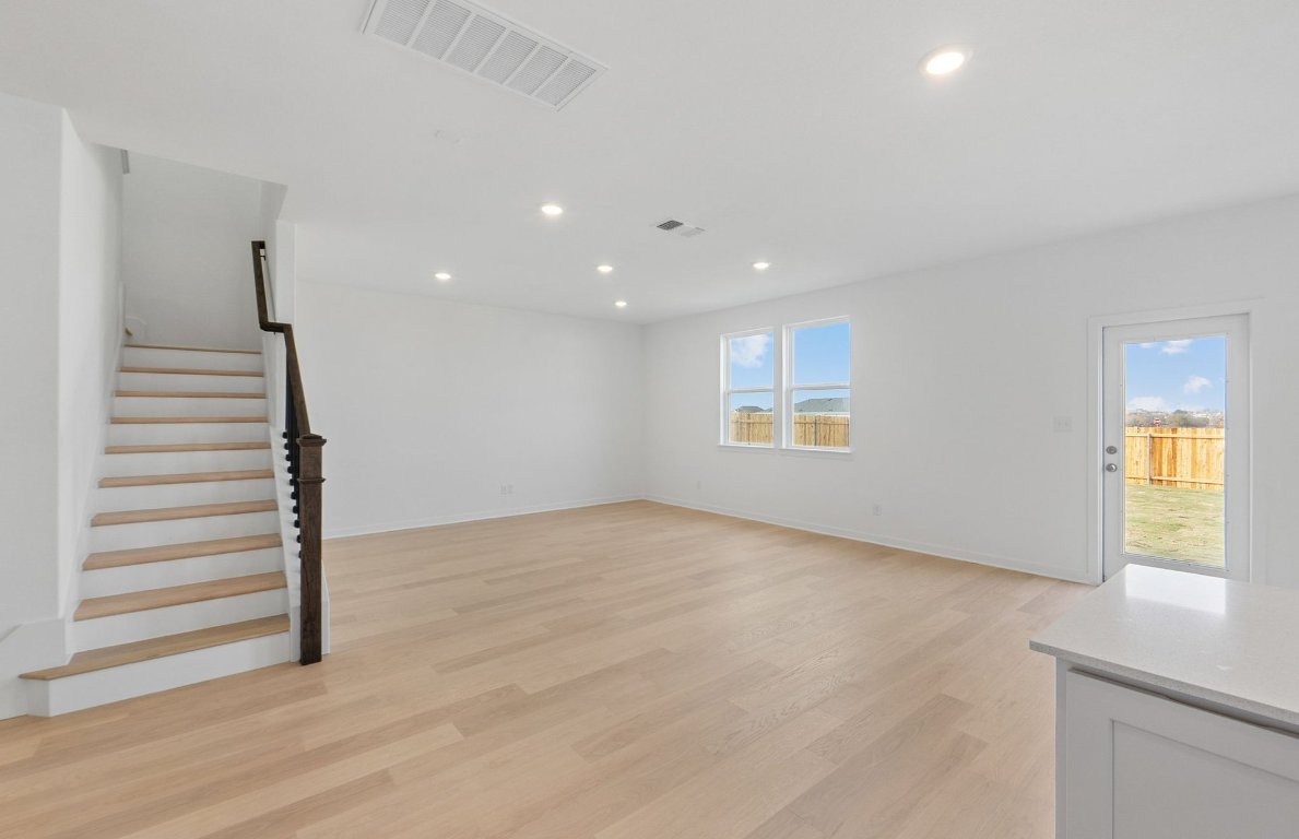 400 Sullivan Way Elgin, TX 78621 - Photo 7 of 30 a view of empty room with wooden floor and fan