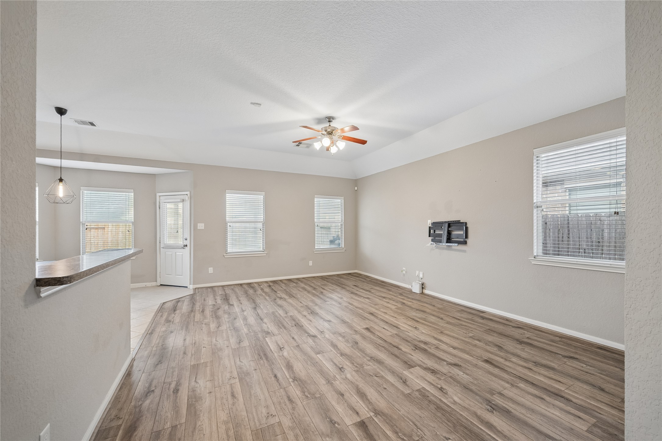 13006 Millstream Bend Lane Tomball, TX 77377 - Photo 5 of 25 a view of an empty room with a window and wooden floor