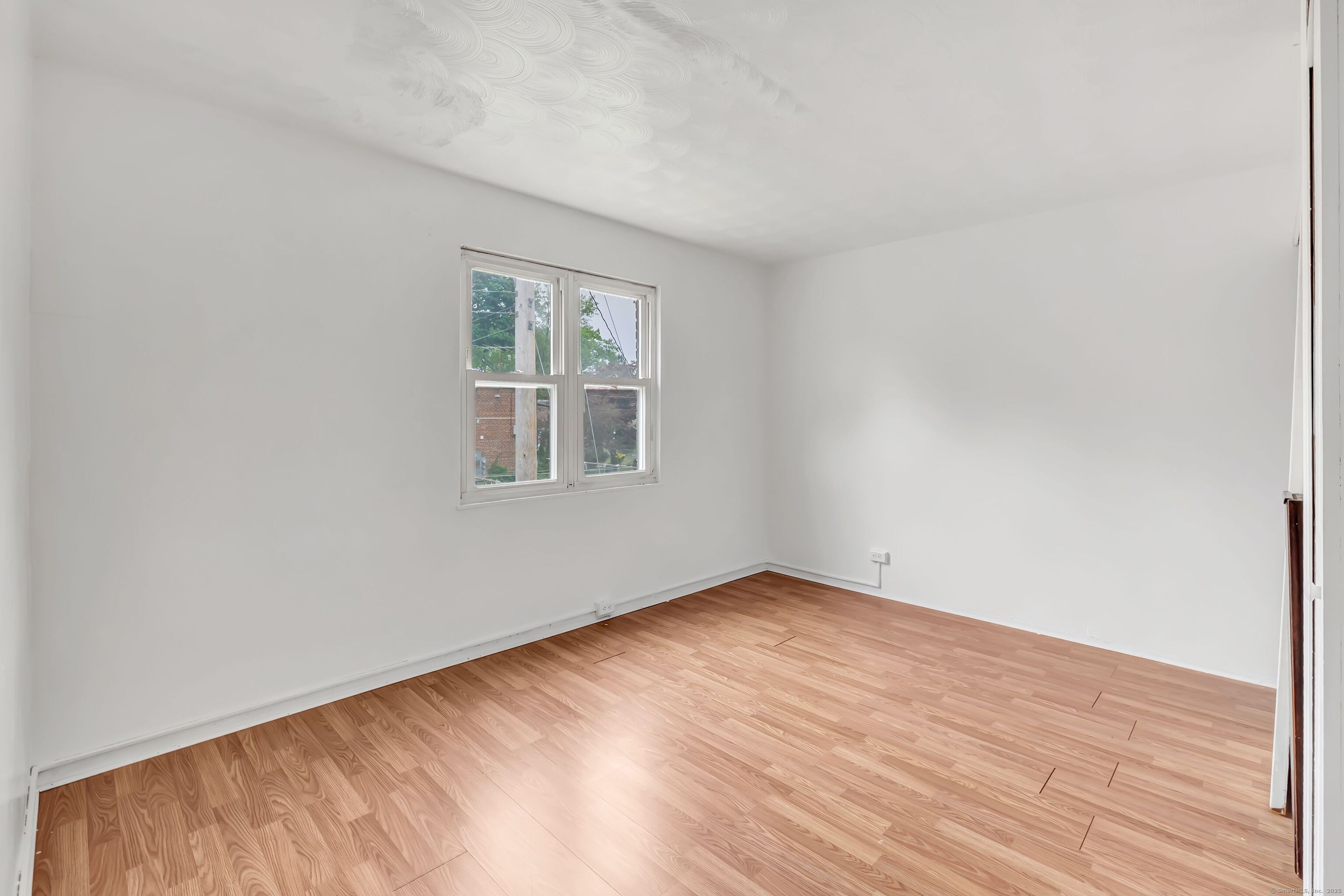 367 D Building 5 Granfield Avenue Bridgeport, CT 06610 - Photo 11 of 13 a view of an empty room with wooden floor and a window