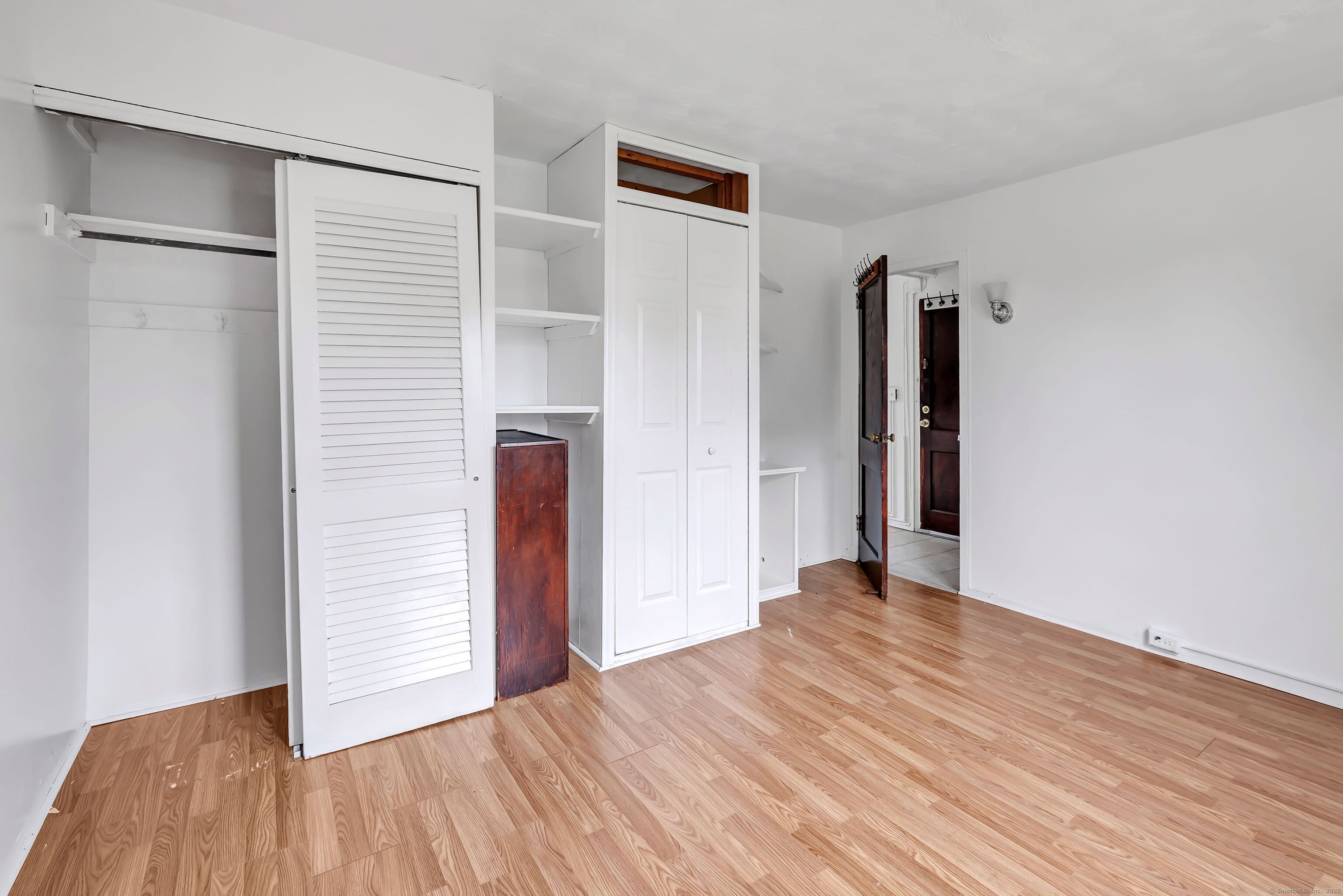 367 D Building 5 Granfield Avenue Bridgeport, CT 06610 - Photo 12 of 13 a view of an empty room with wooden floor and a window